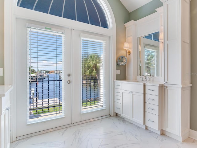 doorway to outside with a healthy amount of sunlight and sink