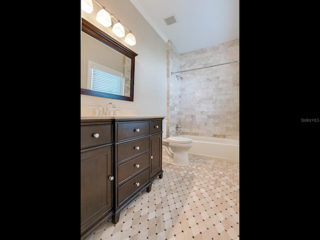 full bathroom featuring toilet, tiled shower / bath, and vanity