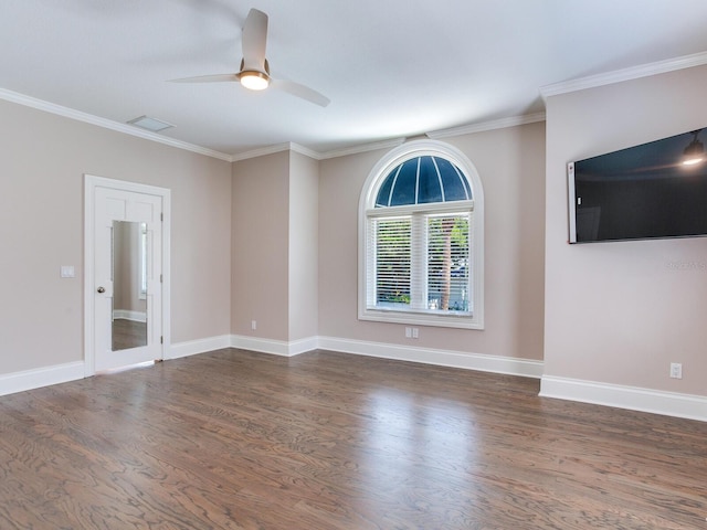 spare room with ornamental molding, dark wood-type flooring, and ceiling fan