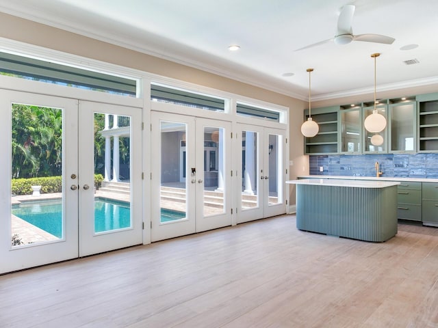 kitchen featuring light hardwood / wood-style flooring, french doors, decorative backsplash, and pendant lighting