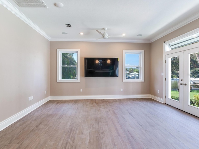 unfurnished living room featuring french doors, light wood-type flooring, and a healthy amount of sunlight