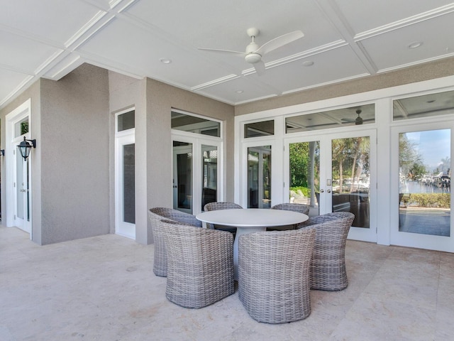 sunroom / solarium with beam ceiling, coffered ceiling, and ceiling fan