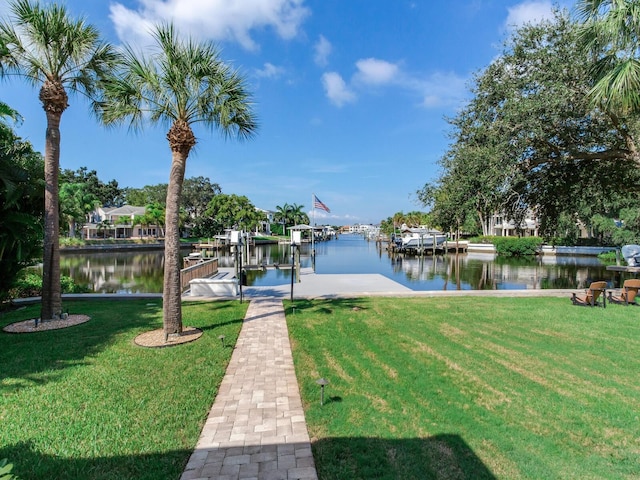 dock area with a water view and a lawn