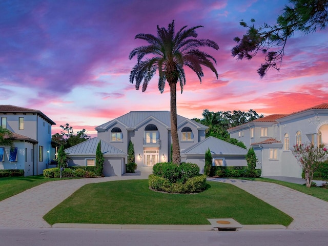 2509 N Dundee St, Tampa, FL 33629 - view of front facade with decorative driveway, a front lawn, a standing seam roof, stucco siding, and a garage
