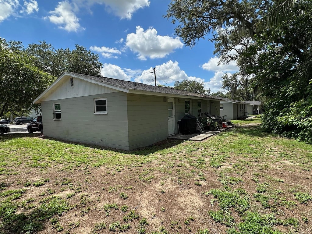 rear view of house with a lawn