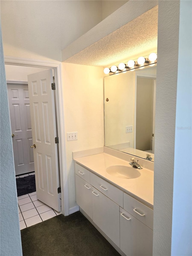 bathroom with vanity, tile patterned flooring, and a textured ceiling