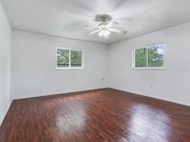 unfurnished room featuring a textured ceiling, dark hardwood / wood-style flooring, and ceiling fan