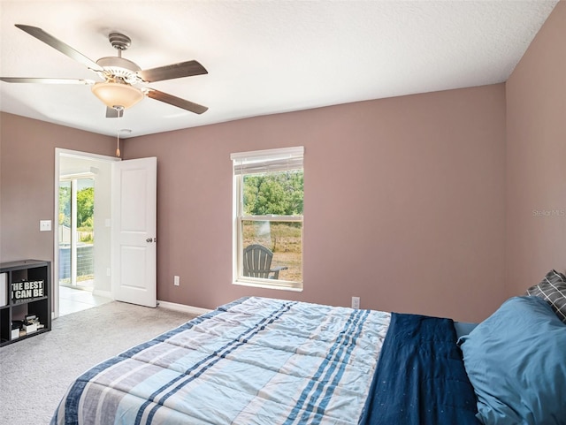 carpeted bedroom with a textured ceiling and ceiling fan