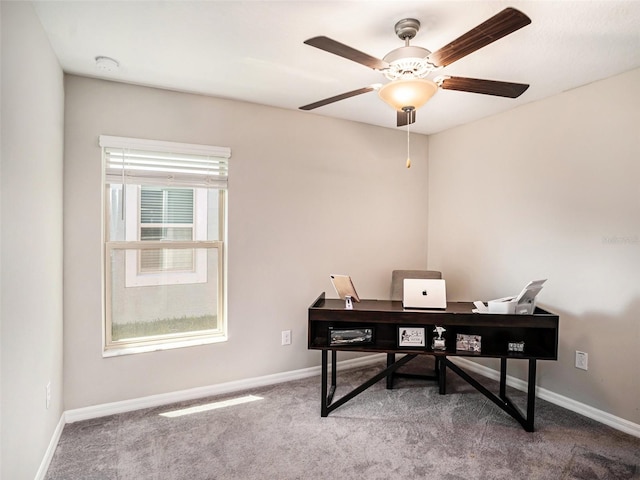 carpeted office space featuring ceiling fan