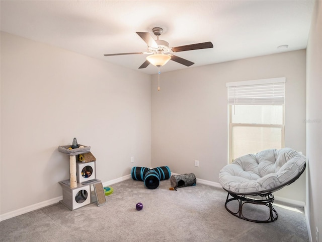 living area with ceiling fan and carpet floors