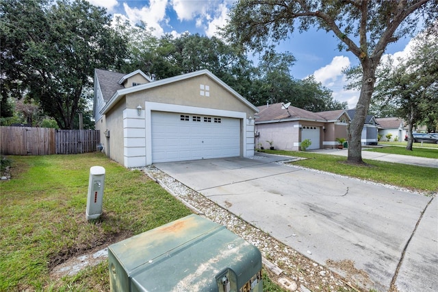 ranch-style home with a garage and a front lawn