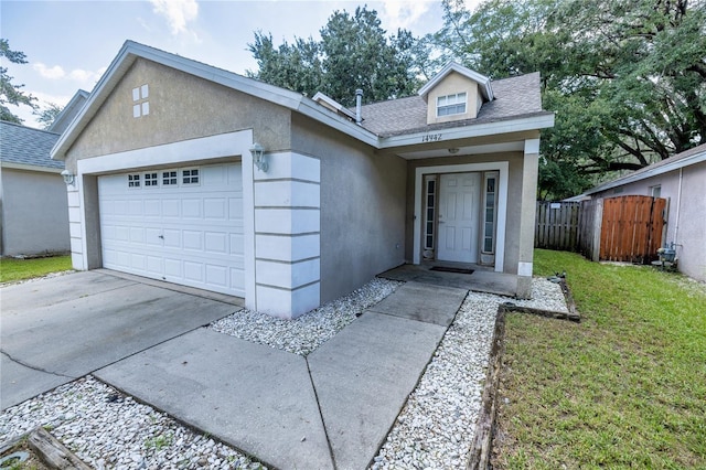 view of front of property with a garage and a front lawn