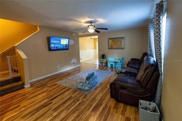 living room featuring ceiling fan and hardwood / wood-style flooring