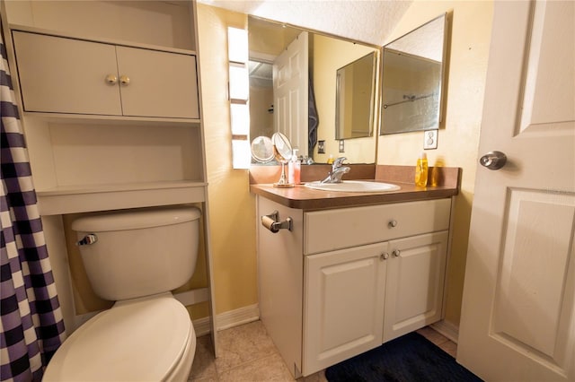 bathroom with a shower with curtain, vanity, tile patterned flooring, and toilet