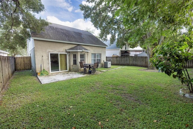 exterior space with a lawn, a patio, and central AC