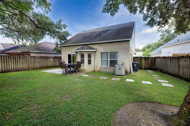 rear view of house with a patio and a yard