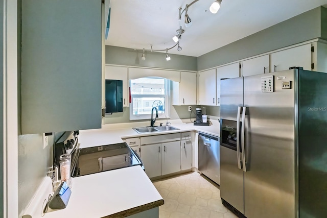 kitchen featuring white cabinets, appliances with stainless steel finishes, and sink