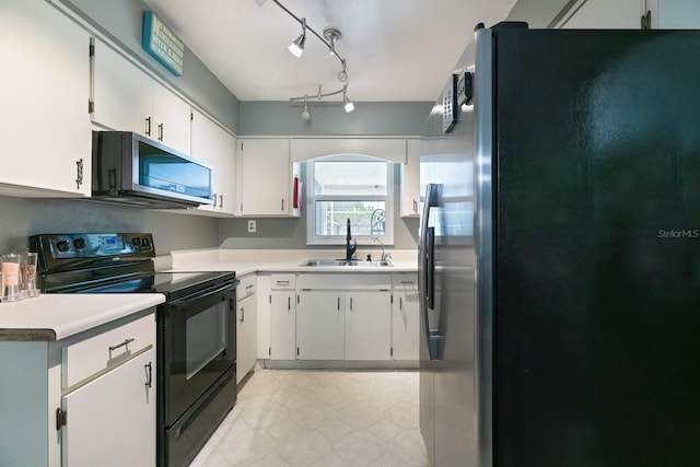 kitchen featuring stainless steel appliances, sink, and white cabinetry