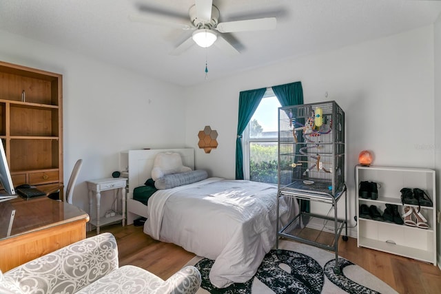 bedroom with wood-type flooring and ceiling fan