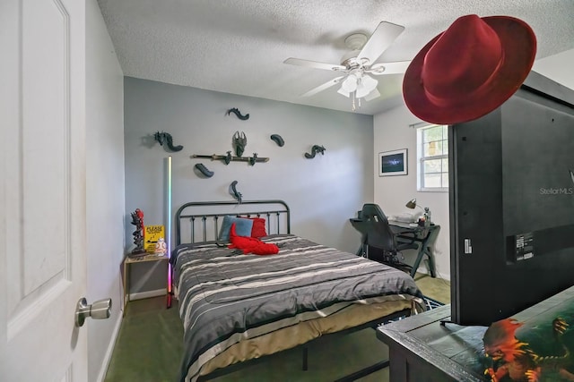 carpeted bedroom featuring ceiling fan and a textured ceiling