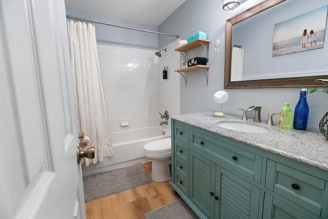 full bathroom with shower / bathtub combination with curtain, vanity, hardwood / wood-style floors, and toilet