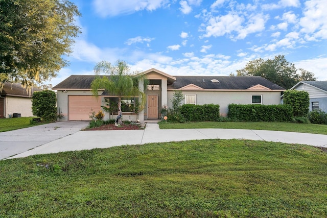 ranch-style home featuring a garage and a front lawn