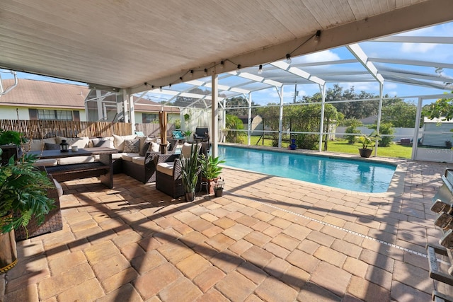 view of swimming pool with glass enclosure, outdoor lounge area, and a patio area