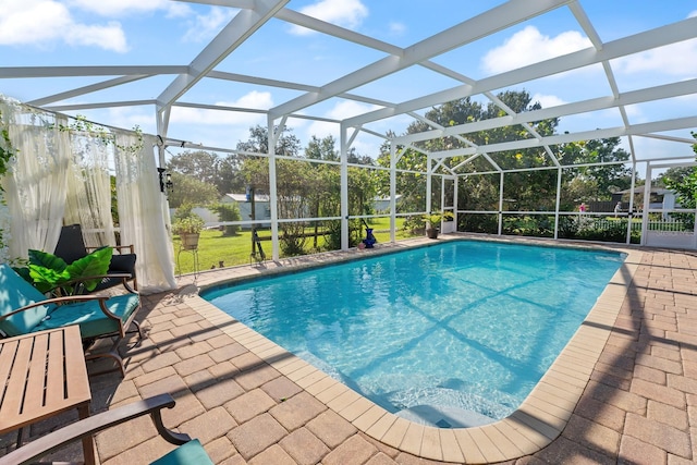 view of pool featuring a patio and glass enclosure