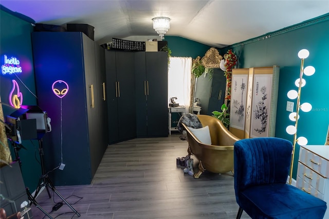 interior space with wood-type flooring and lofted ceiling