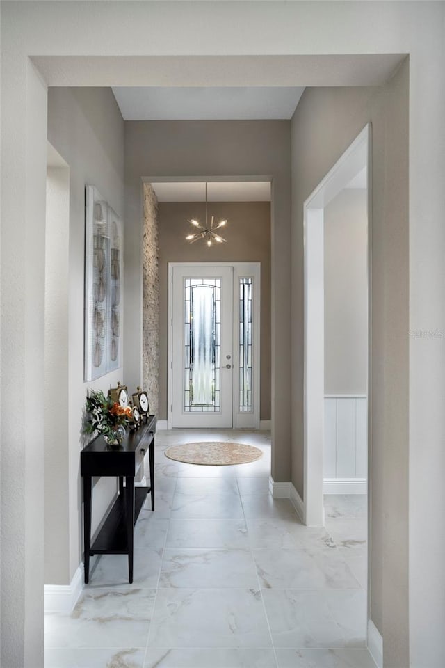 entrance foyer featuring a notable chandelier