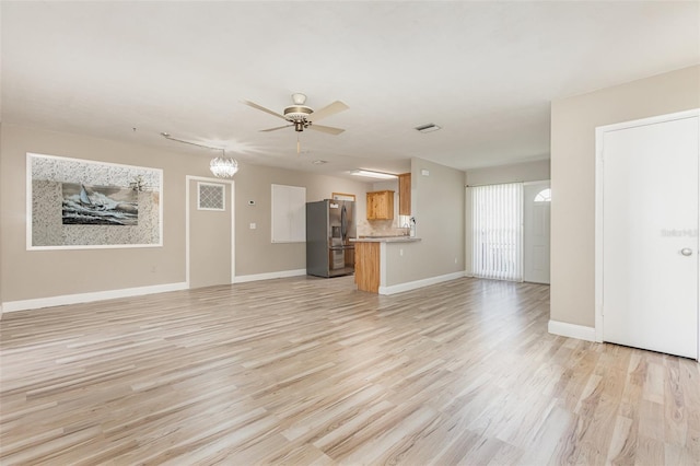 unfurnished living room with ceiling fan and light hardwood / wood-style floors