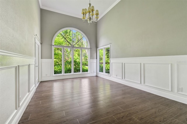 empty room with ornamental molding and an inviting chandelier