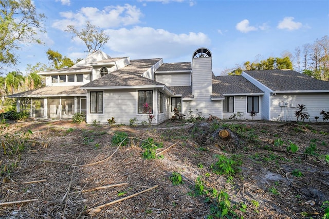 back of house featuring a sunroom