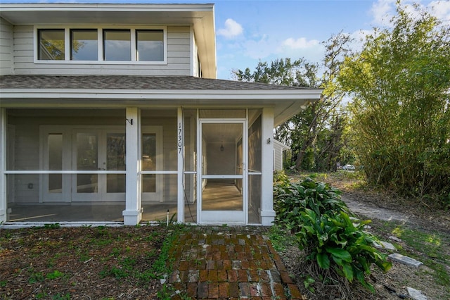 view of home's exterior with a sunroom