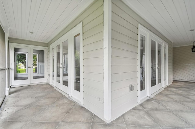 unfurnished sunroom featuring french doors and wooden ceiling