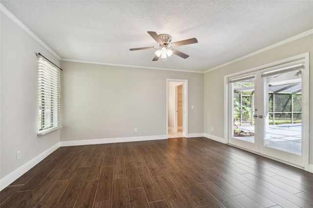 spare room with ornamental molding, a healthy amount of sunlight, and dark wood-type flooring