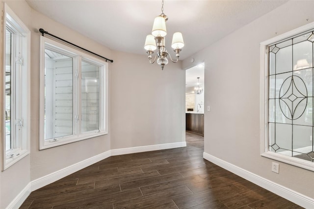 unfurnished dining area featuring a healthy amount of sunlight and an inviting chandelier