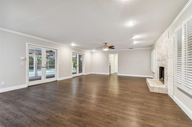 unfurnished living room featuring dark wood-type flooring, ornamental molding, french doors, and ceiling fan