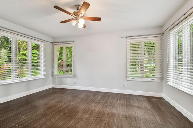 spare room with dark hardwood / wood-style floors and ceiling fan