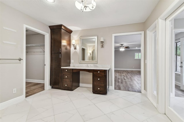 bathroom featuring ceiling fan and vanity