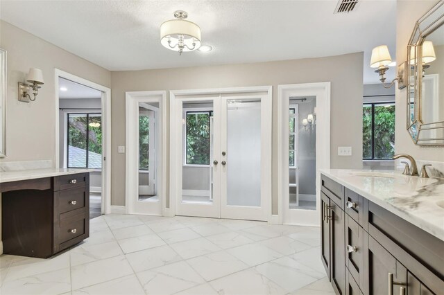 bathroom featuring french doors and vanity