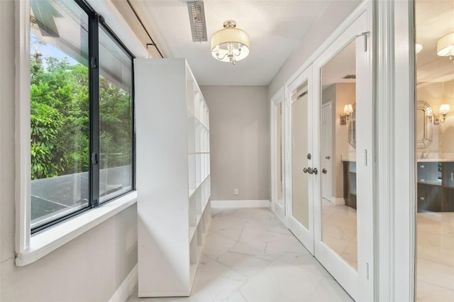 hall featuring french doors and a wealth of natural light