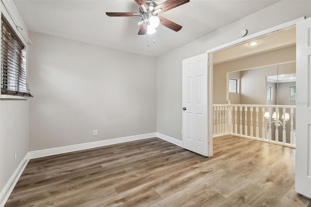 unfurnished room with hardwood / wood-style floors and ceiling fan