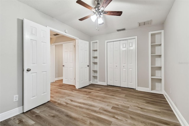 unfurnished bedroom with hardwood / wood-style flooring and ceiling fan