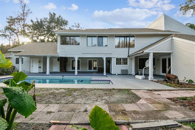 back of property with a patio area and french doors