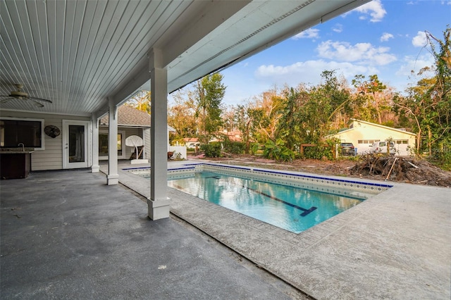 view of swimming pool with a patio and ceiling fan