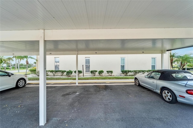 view of parking / parking lot featuring a carport