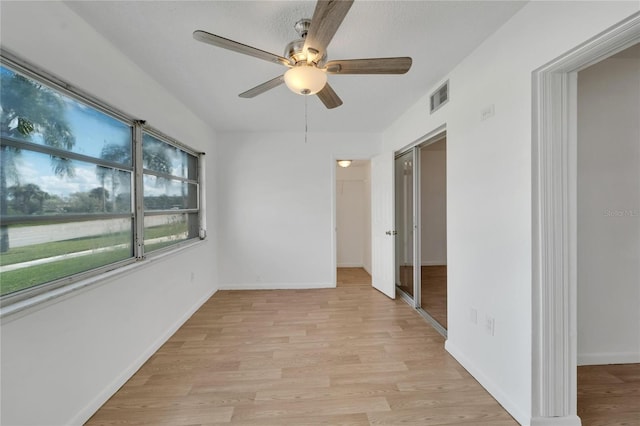 spare room featuring ceiling fan and light hardwood / wood-style flooring