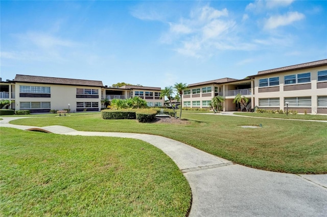 view of home's community with a yard