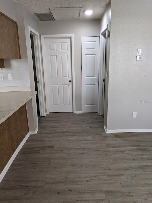 hallway with dark hardwood / wood-style floors